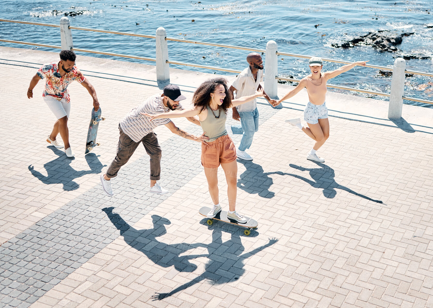 Buy stock photo Full length shot of a diverse group of friends bonding during a day outdoors