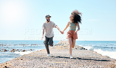 Buy stock photo Full length shot of a young couple bonding and holding hands while running outdoors