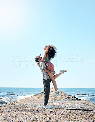 Buy stock photo Full length shot of a happy young couple bonding during a day outdoors