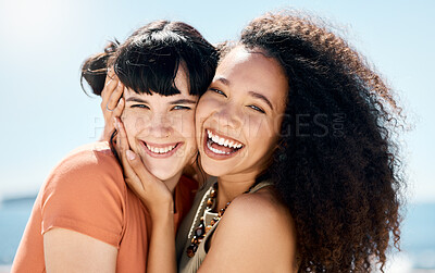 Buy stock photo Shot of two young women standing together and bonding during a day outdoors