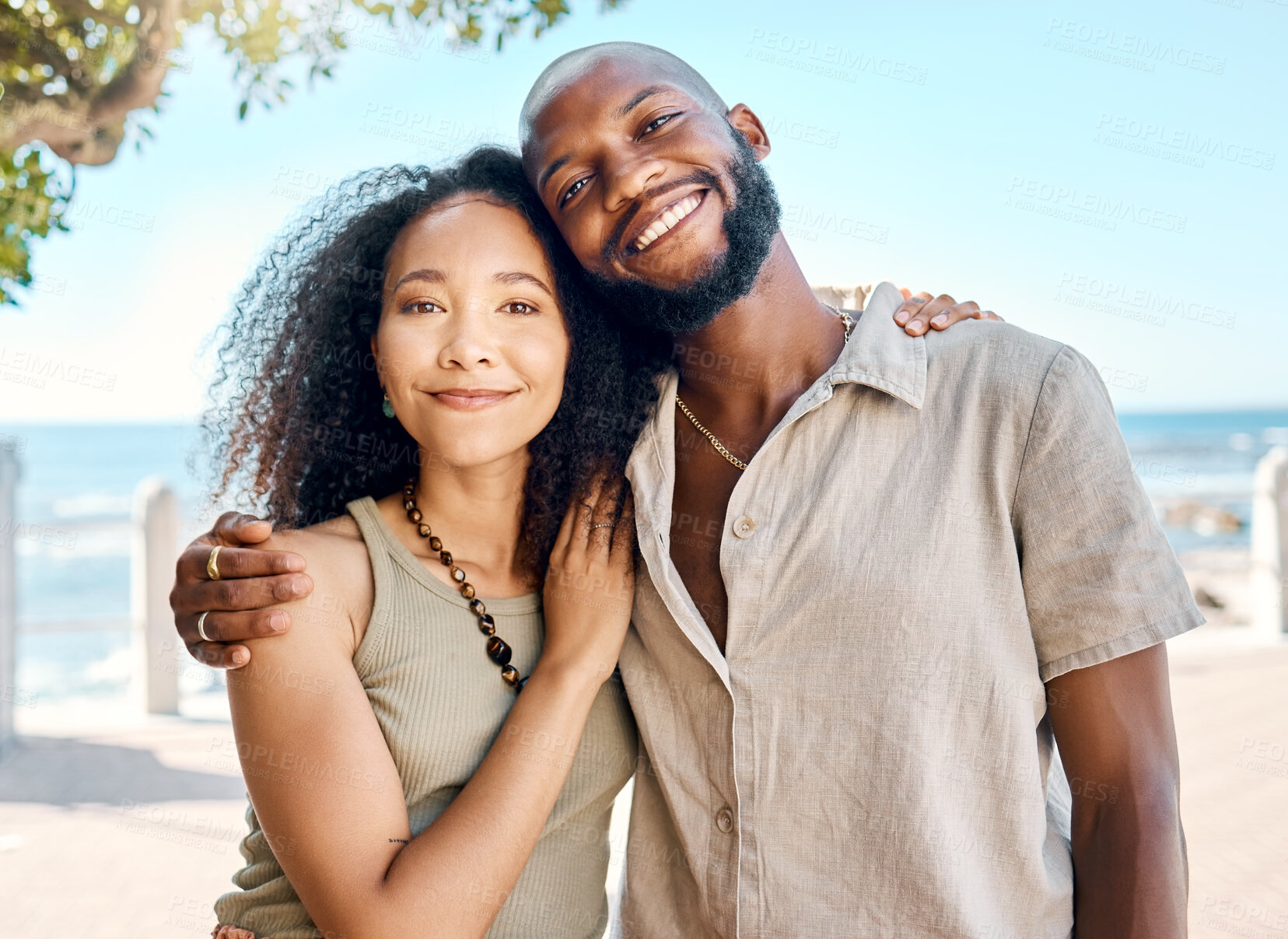 Buy stock photo Shot of a young couple standing outside together and bonding