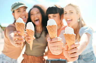 Buy stock photo Cropped portrait of a group of attractive young girlfriends enjoying ice creams on the beach