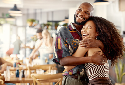 Buy stock photo Shot of a young couple hugging during a trip to a restaurant