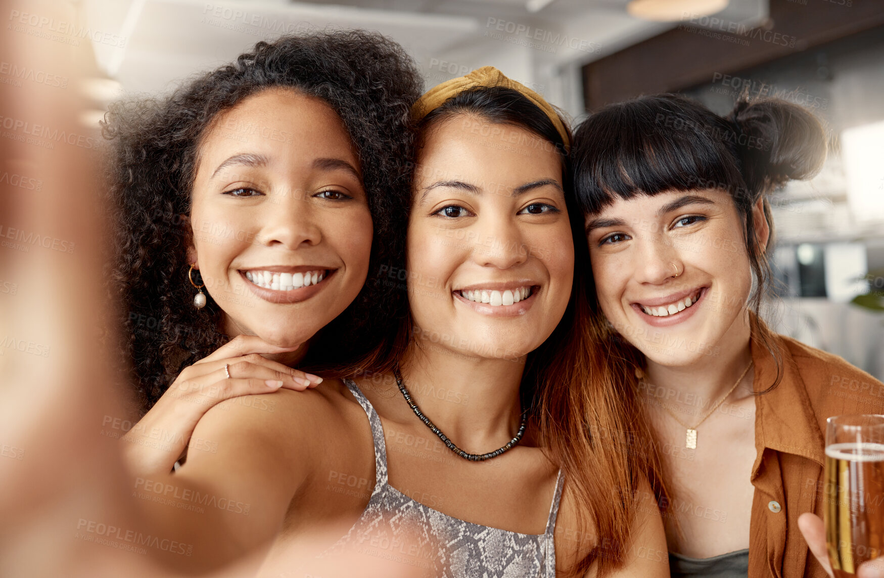 Buy stock photo Shot of a group of young friends taking selfies together at a restaurant