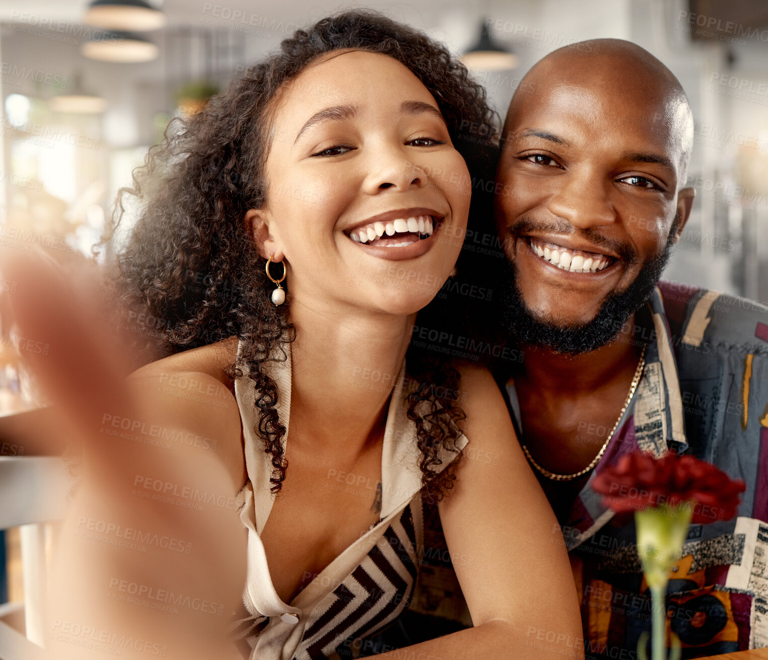 Buy stock photo Shot of a young couple on a date at a restaurant taking selfies