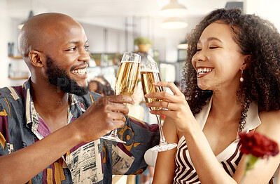 Buy stock photo Shot of a young couple in love toasting with champagne during a date