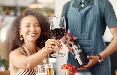 Buy stock photo Shot of a young woman toasting with a glass of red wine