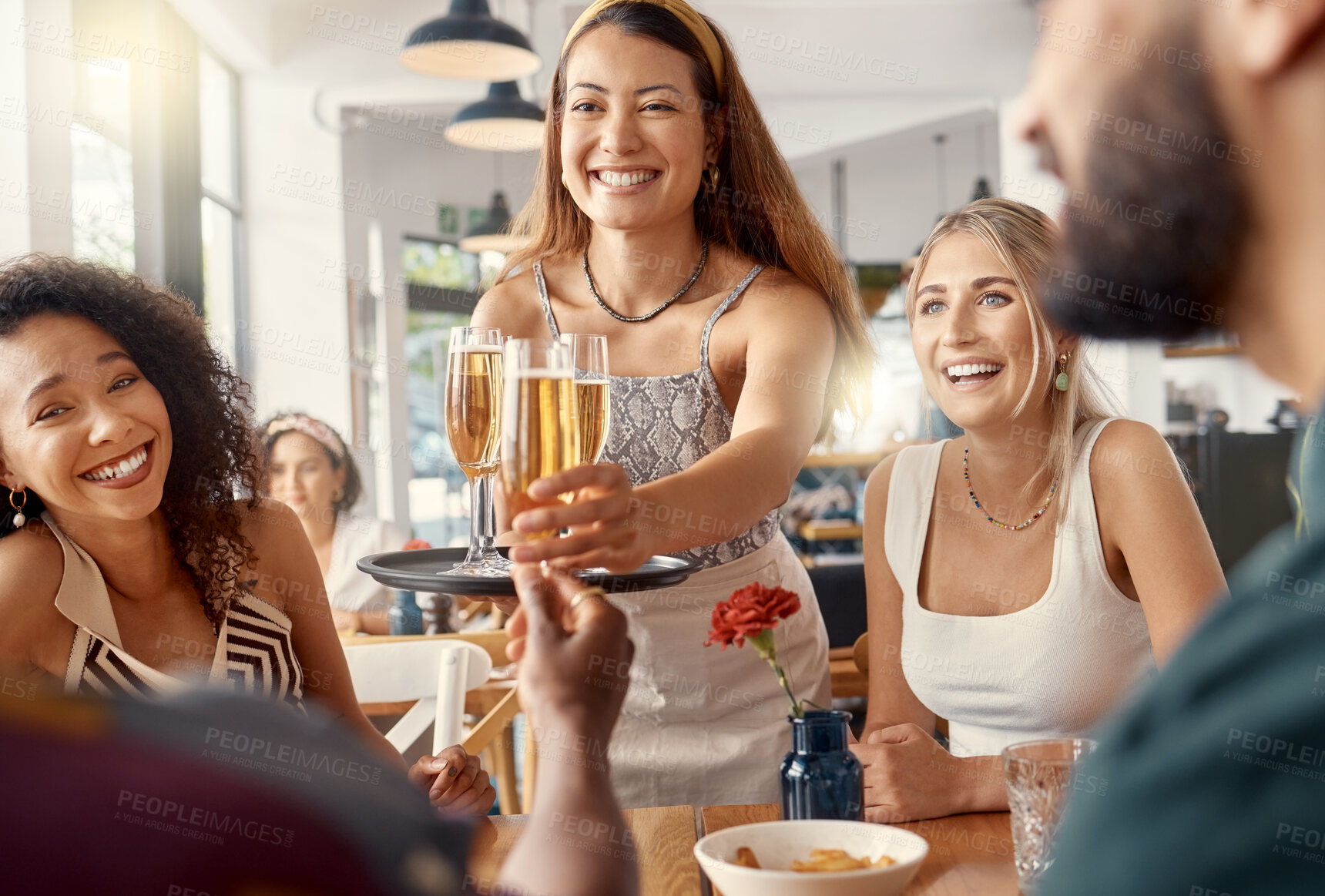 Buy stock photo Shot of a group of friends toasting in restaurant