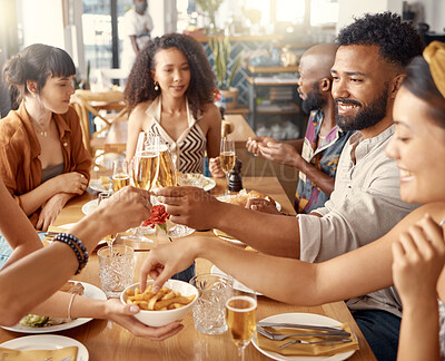 Buy stock photo Shot of a group of friends toasting in restaurant