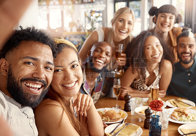 Buy stock photo Shot of a group of young friends taking selfies together at a restaurant
