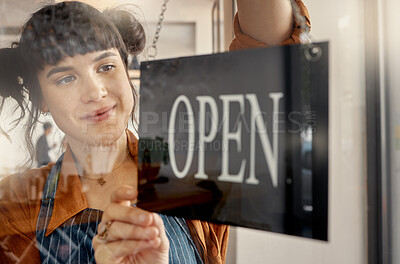 Buy stock photo Shot of a young business owner hanging up an open for business sign