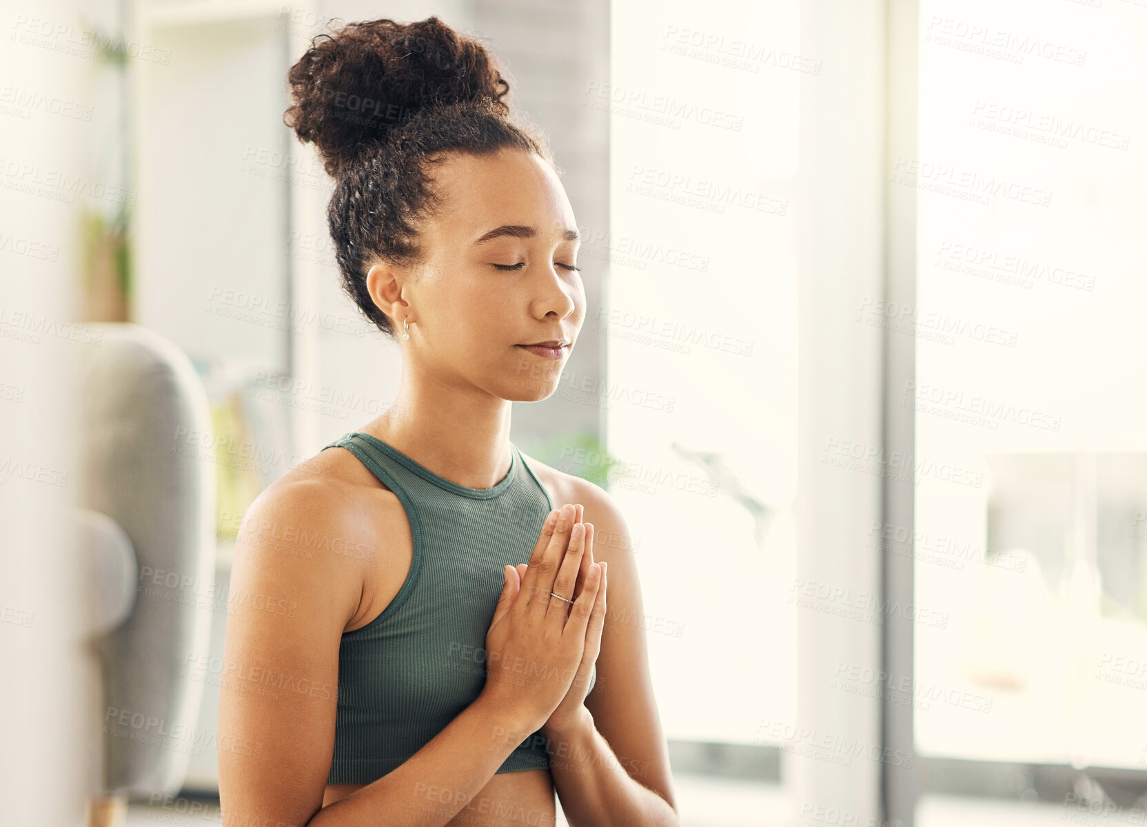 Buy stock photo Praying hands, relax and meditation by woman in a living room for peace, wellness or mental health balance at home. Prayer pose, yoga and lady meditate in lounge for zen, healing or holistic exercise