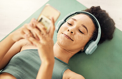 Buy stock photo Relax, phone and yoga woman with music headphones on floor for fitness, break or texting at home from above. Workout, rest and sporty lady with smartphone and earphones for wellness, app or podcast