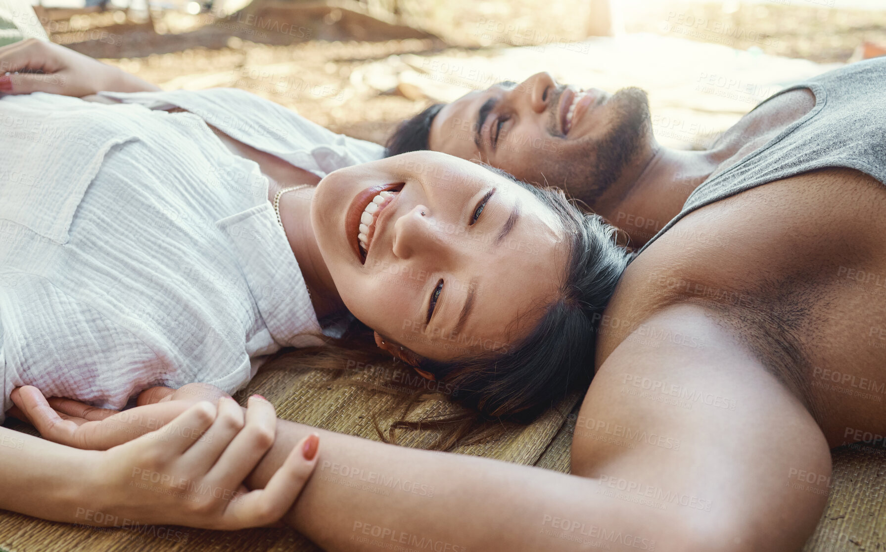 Buy stock photo Hiking, camping and a young couple lying on the ground together outdoor in nature for travel or adventure. Love, smile or freedom with a happy asian woman and her boyfriend bonding in the wilderness