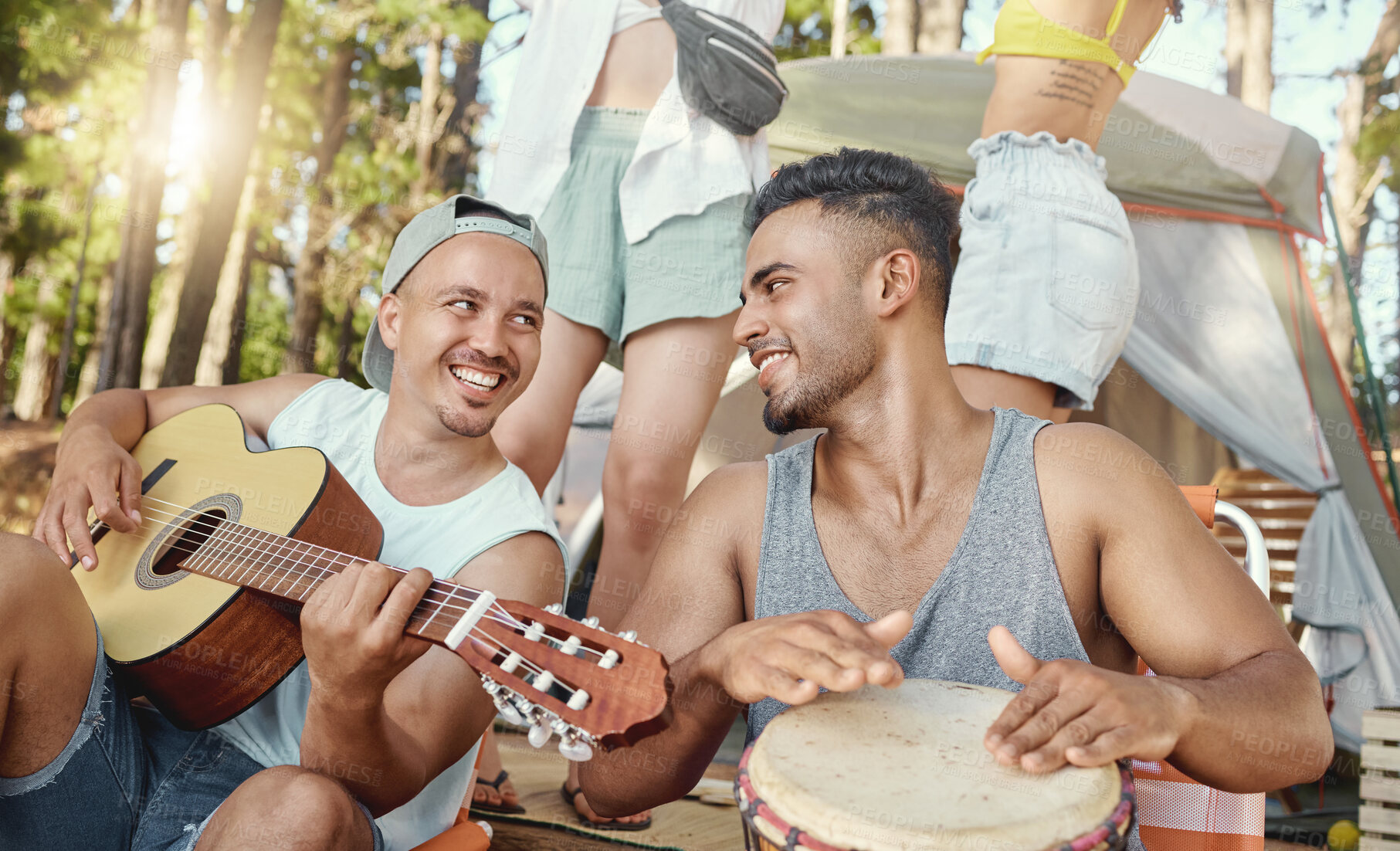 Buy stock photo Musician, friends and playing music with guitar and drum on a summer camping, holiday in the woods, forest or nature. Men, happiness and people together for musical performance, song or band