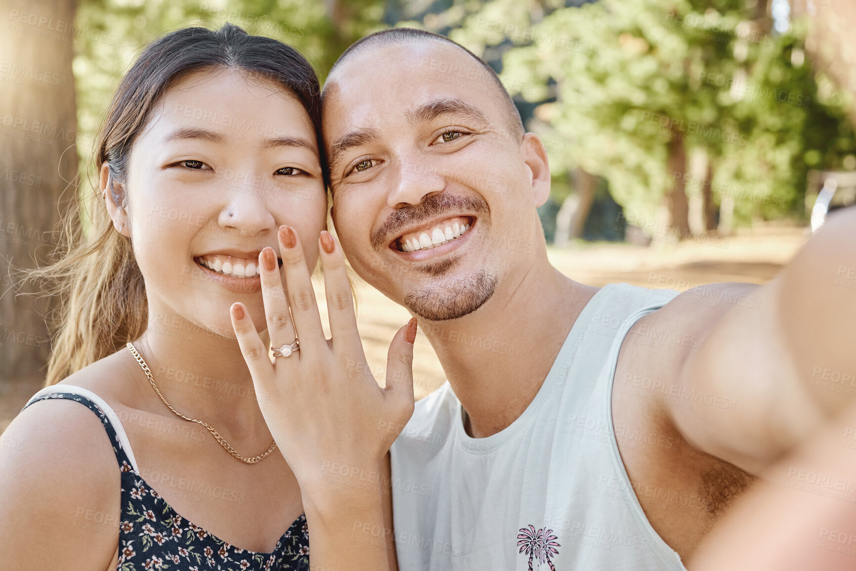 Buy stock photo Selfie, engagement and portrait of couple in nature by outdoor park, garden or woods. Happy, smile and interracial engaged man and woman taking picture after romantic proposal with love and happiness
