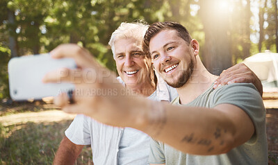 Buy stock photo Senior man, son and camping with selfie, smile and outdoor in forrest for vacation, adventure and social media app. Guy, elderly person and profile picture for memory, blog or photography in woods