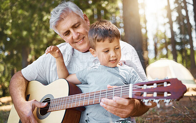 Buy stock photo Senior man, boy and camping with guitar, music and teaching with freedom, smile or outdoor in summer. Grandfather, instrument and male child in forest, learning and retirement on vacation in nature