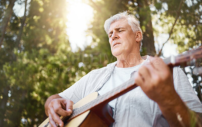 Buy stock photo Senior man, guitar and woods for camping, music and relax with freedom, peace and outdoor in summer. Elderly guy, instrument and performance in forrest, sunshine and retirement on vacation in nature