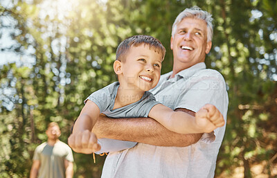 Buy stock photo Hiking, family and a boy flying with his grandfather outdoor in nature while camping in the forest or woods. Love, fun and a young male child playing with his senior grandparent in the wilderness