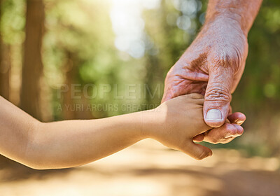 Buy stock photo Closeup, holding hands and senior man with son, forest or support with peace, love or care with bonding. Zoom, male person or kid touching palms, helping hand or freedom in nature, adventure and walk