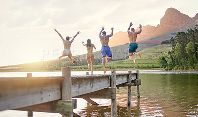 Buy stock photo Lake, jump and group of friends for holiday, summer camping and freedom, celebration or success from behind. carefree, cheers and excited people in air for swimming, water and mountains on vacation