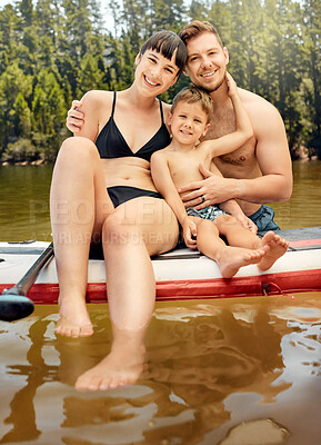 Buy stock photo Lake, family on paddle board and relax outdoor, summer holiday and travel in portrait. Adventure, freedom and fun, man and woman with boy child in swimsuit, vacation and bonding together in nature