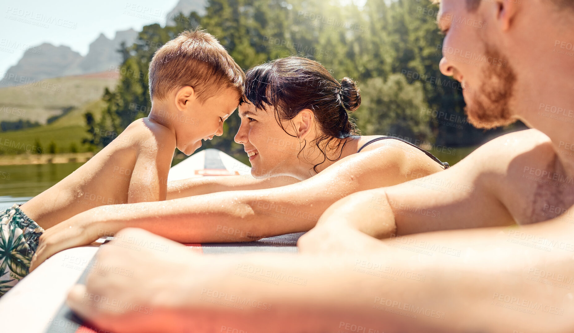 Buy stock photo Nature, bonding and family swimming in a lake together while on vacation or adventure in the woods. Happy, love and mother embracing her boy child while having fun in pond on holiday or weekend trip.