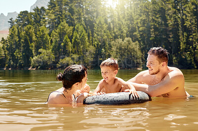 Buy stock photo Parents, son and float on lake with inflatable, smile and excited for camping, vacation or swimming together. Man, woman and male child with happy family, holiday and tube on river in summer in woods
