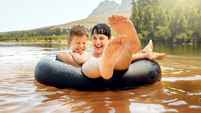 Buy stock photo Lake, swimming and mother with child in water while camping in a forest for vacation or holiday together. Travel, inflatable ring and parent bonding with kid in nature for freedom, love and happiness