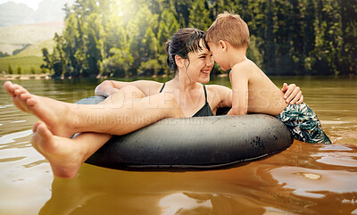 Buy stock photo Lake, inflatable ring and mother with child in water while camping in a forest for vacation or holiday together. Travel, swimming and parent bonding with kid in nature for freedom, love and happiness