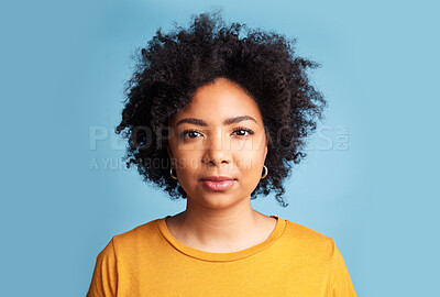 Buy stock photo Portrait, woman and serious mindset on blue background in studio with natural beauty, confidence and focus. Face, college student and girl with a healthy afro or African haircare in salon