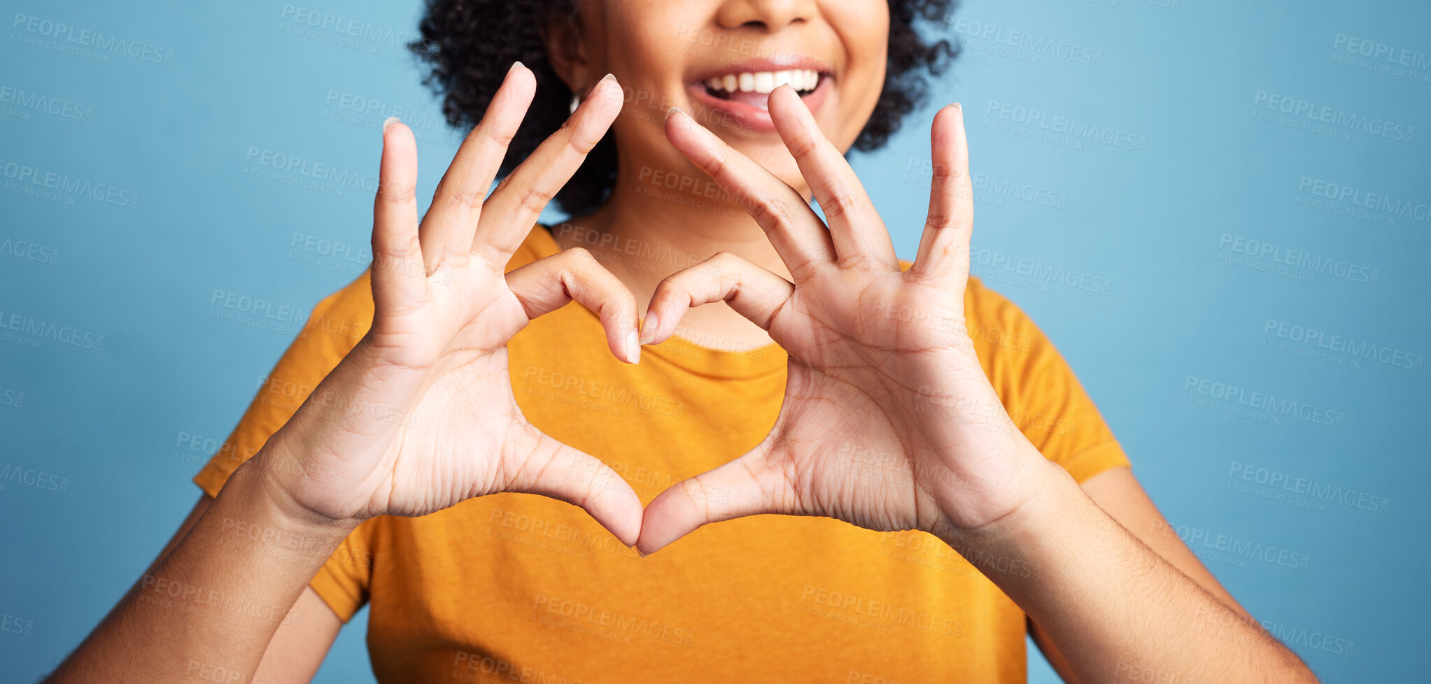 Buy stock photo Happy, hand and closeup of a heart shape for romance, care or flirting expression in a studio. Happiness, positive and zoom of a woman with a love gesture, emoji or sign isolated by a blue background
