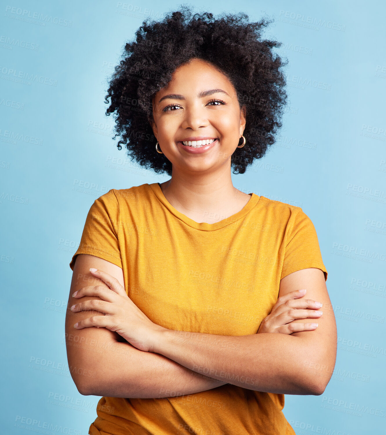 Buy stock photo Happy, woman and portrait with arms crossed, confidence and natural beauty blue background in studio. Face, happiness and person with African hair, afro or student in college with pride