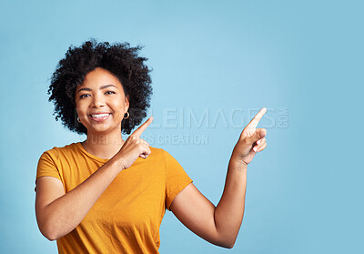Buy stock photo Happy, portrait of woman pointing and against blue background for giveaway. Direction or marketing, advertising or product placement and female person pose with hand gesture in studio backdrop