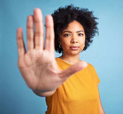 Buy stock photo Stop hand, serious woman and portrait in studio isolated on a blue background. African person, face and ban, rejection or warning, refuse and no palm sign to protest racism, human rights and emoji.