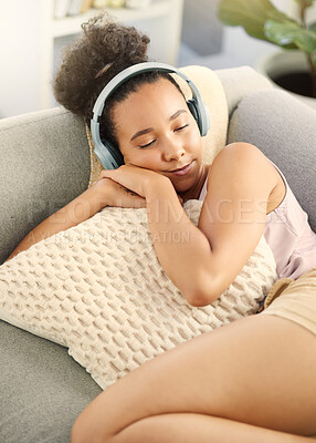 Buy stock photo Sleeping, music headphones and woman on sofa in home living room for streaming. Meditation, couch and African person listening to radio, audio or podcast, jazz and sound for calm, peace and relax.