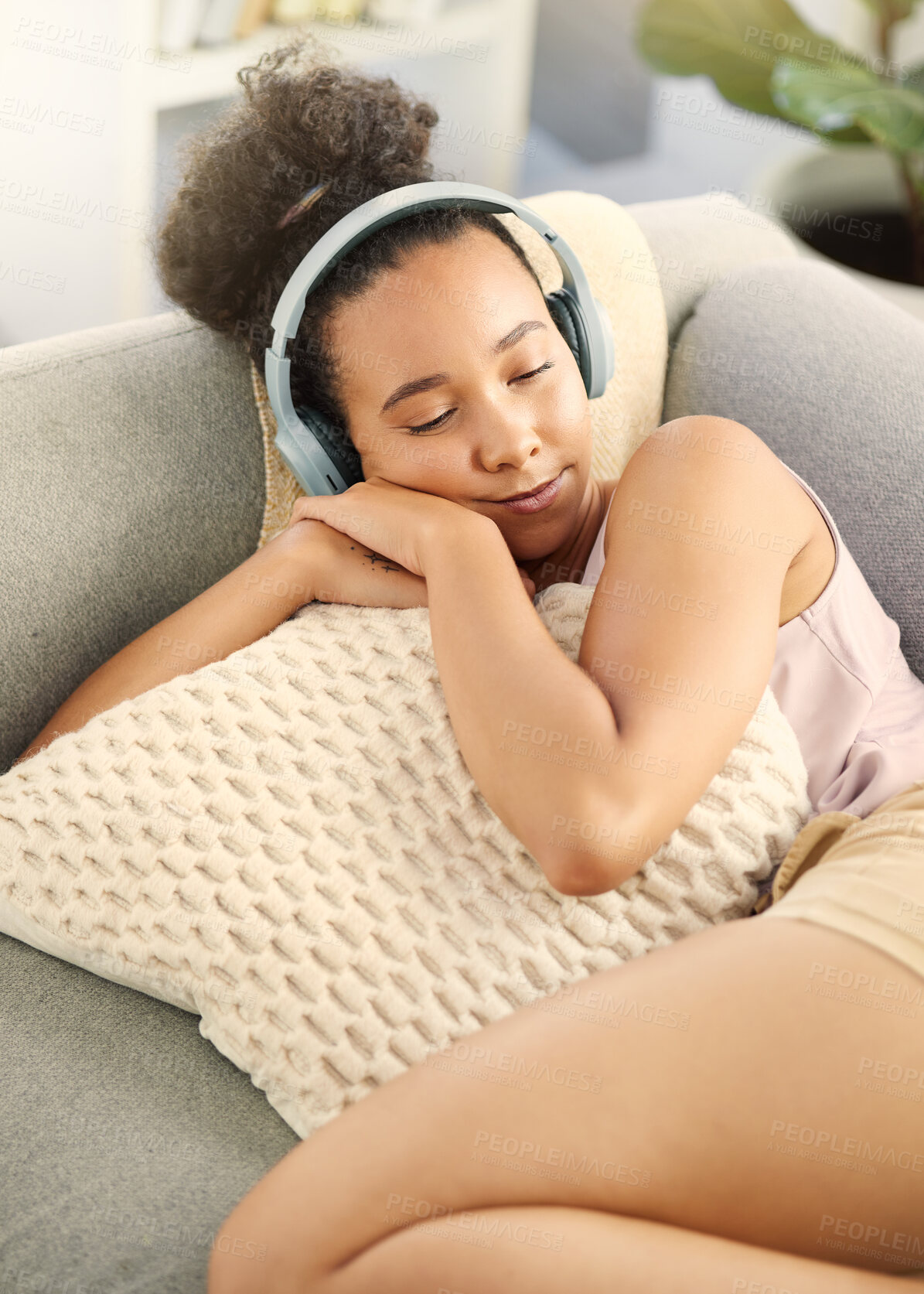 Buy stock photo Sleeping, music headphones and woman on sofa in home living room for streaming. Meditation, couch and African person listening to radio, audio or podcast, jazz and sound for calm, peace and relax.