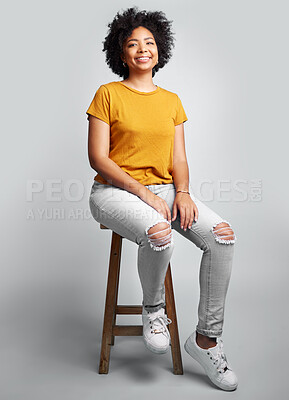 Buy stock photo Portrait, smile and woman sitting on stool in studio isolated on a white background. Chair, confidence and happy African female person from South Africa with stylish fashion, gen z or trendy clothing