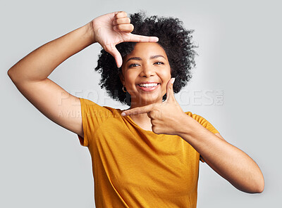 Buy stock photo Portrait, finger frame and happy woman in white background, studio and review profile picture. Face, young female model and hands to border perspective, cool selfie and smile for creative photography