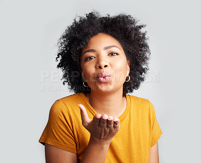 Buy stock photo Portrait, woman and blowing kiss in white background, studio and backdrop of love, romance and flirting lips. Happy african female model, air kissing and emoji for happiness, joy and valentines day