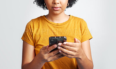 Buy stock photo Woman, hands and texting on cellphone in studio for notification, social media post and online chat. Closeup female model typing on smartphone, mobile app download and technology on white background