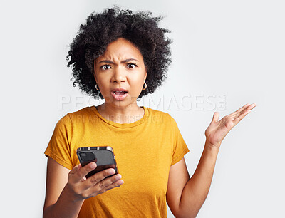 Buy stock photo Portrait, young woman and surprised with phone on hand   and omg with text or spam on social media and online news. Technology, communication and scam announcement on grey studio background.