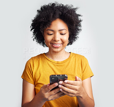 Buy stock photo Happy, woman and cellphone texting on white background of notification, social media post and online chat. Young african female model typing on smartphone, mobile app or download technology in studio