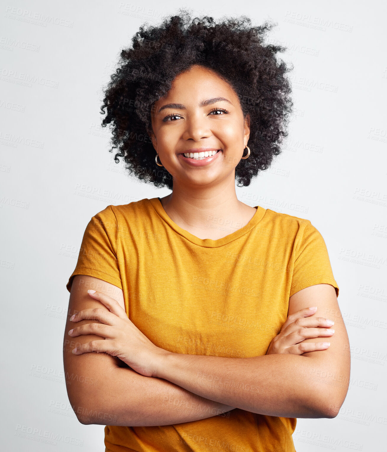 Buy stock photo Portrait of happy, woman, arms crossed and confident in studio, white background and backdrop. Young african female model smile with natural curly hair, positive face and gen z girl of South Africa