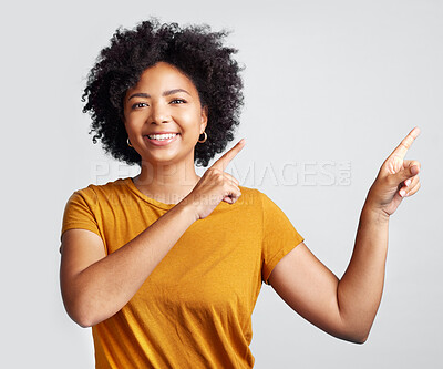 Buy stock photo Portrait of happy woman, advertising and pointing to studio offer, information and brand coming soon. African female model gesture to announcement, sales promotion or presentation on white background
