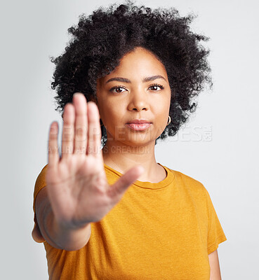 Buy stock photo Woman, stop and hand in studio portrait for human rights abuse, racism and afro by gray background. Girl model, gesture or activism for discrimination, justice or protest for freedom, peace or vote
