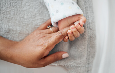 Buy stock photo Shot of a mother holding her baby's hand
