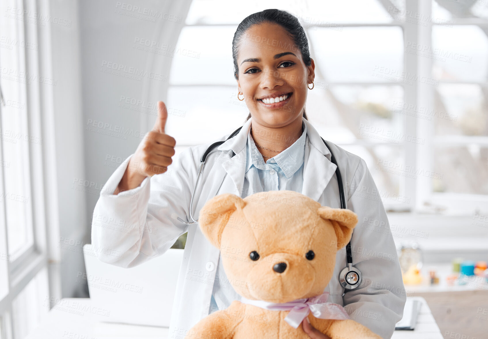 Buy stock photo Portrait, doctor and thumbs up with teddy bear in hospital or clinic for healthcare or wellness. Female person, pediatrician and happiness for child in medical services, advice and support with pride