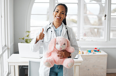 Buy stock photo Portrait, doctor and thumbs up with teddy bear in clinic or hospital for healthcare or wellness. Female person, paediatrician and happiness for child in medical services, advice and support with pride